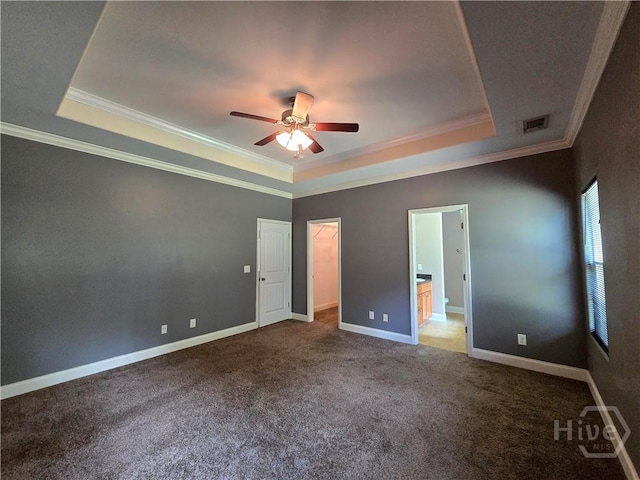 6 Sagefield Dr, Ellabell, GA 31308 - unfurnished bedroom with a tray ceiling, crown molding, carpet flooring, a spacious closet, and baseboards