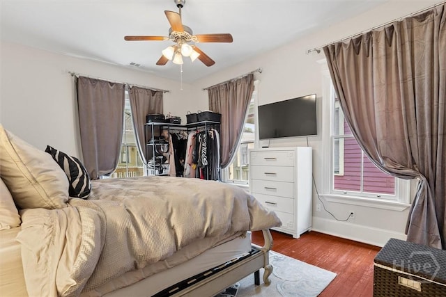 1722/1724 Barnard St, Savannah, GA 31401 - bedroom featuring multiple windows, baseboards, wood finished floors, and ceiling fan