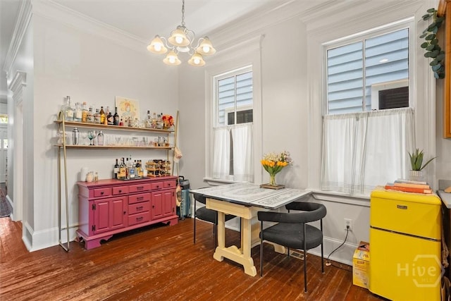 1722/1724 Barnard St, Savannah, GA 31401 - dining area featuring a chandelier, baseboards, crown molding, dark wood-style flooring, and a bar