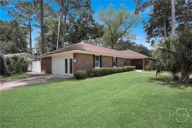 1 Black Forest Dr, Savannah, GA 31410 - view of front of house featuring brick siding, a front yard, french doors, and concrete driveway