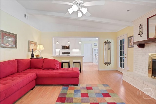 1 Black Forest Dr, Savannah, GA 31410 - living room with light wood finished floors, a ceiling fan, and a fireplace