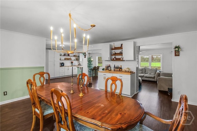 737 Te Glisson Rd, Ellabell, GA 31308 - dining space featuring dark wood-style floors, a chandelier, baseboards, and crown molding