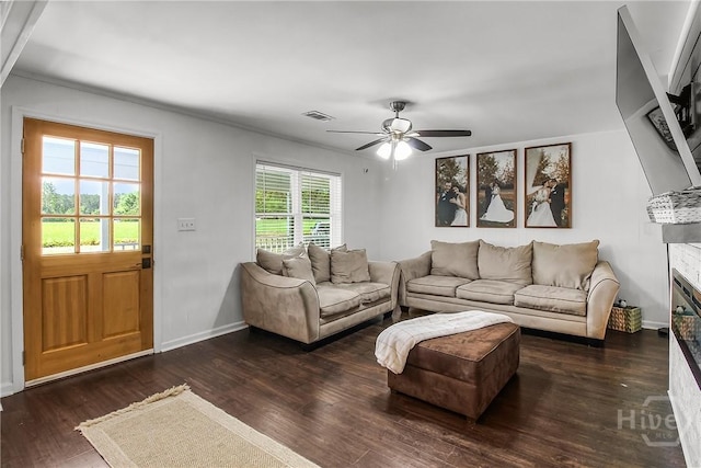 737 Te Glisson Rd, Ellabell, GA 31308 - living area with a ceiling fan, wood finished floors, baseboards, a glass covered fireplace, and crown molding