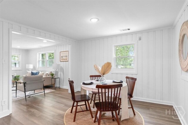 72 Bazemore Ave, Savannah, GA 31408 - dining room with wood finished floors, healthy amount of natural light, a decorative wall, and baseboards