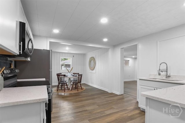 72 Bazemore Ave, Savannah, GA 31408 - kitchen with electric range, a sink, white cabinets, dark wood finished floors, and recessed lighting