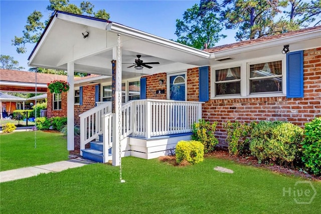 2006 Cokesbury Dr, Savannah, GA 31406 - view of front facade featuring brick siding, a ceiling fan, a front yard, and covered porch