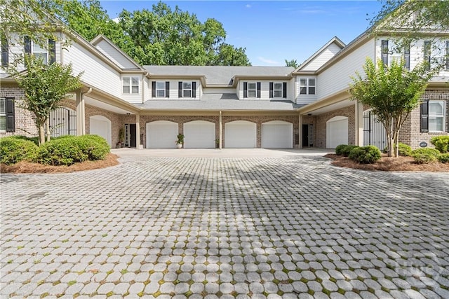 204 River Oaks Dr, Richmond Hill, GA 31324 - townhome / multi-family property featuring brick siding and decorative driveway