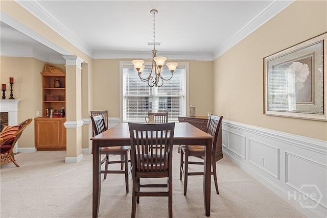 204 River Oaks Dr, Richmond Hill, GA 31324 - dining area featuring a chandelier, light carpet, ornamental molding, a fireplace, and decorative columns