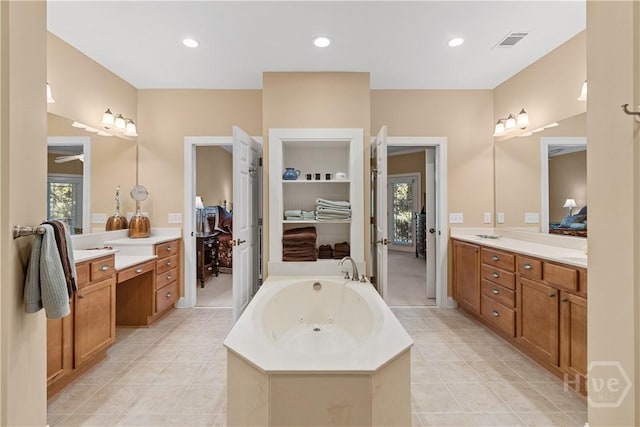 204 River Oaks Dr, Richmond Hill, GA 31324 - bathroom featuring vanity, a jetted tub, tile patterned flooring, and recessed lighting