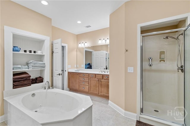 204 River Oaks Dr, Richmond Hill, GA 31324 - bathroom with a stall shower, a tub with jets, double vanity, baseboards, and tile patterned flooring