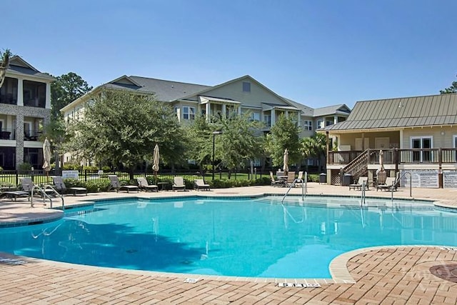 204 River Oaks Dr, Richmond Hill, GA 31324 - community pool with stairs and a patio area