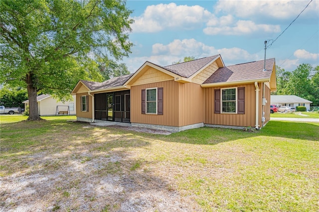 145 New Stillwell Rd, Springfield, GA 31329 - view of home's exterior with roof with shingles, a lawn, and a sunroom