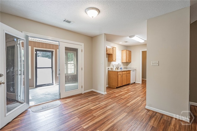 145 New Stillwell Rd, Springfield, GA 31329 - kitchen featuring dishwasher, light wood finished floors, light countertops, baseboards, and a textured ceiling