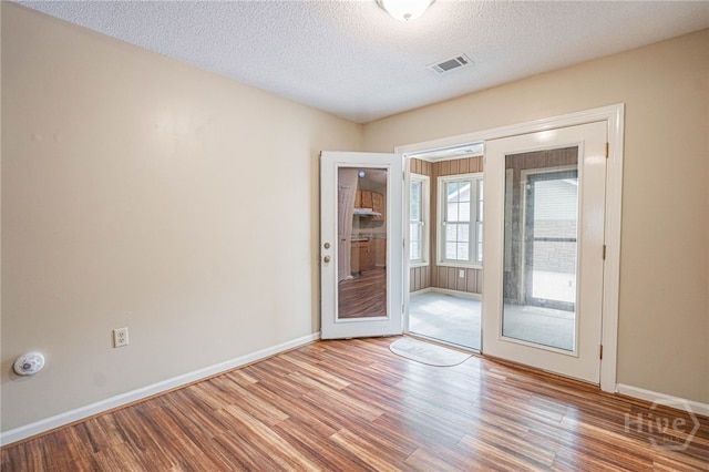 145 New Stillwell Rd, Springfield, GA 31329 - empty room with wood finished floors, baseboards, a textured ceiling, and french doors
