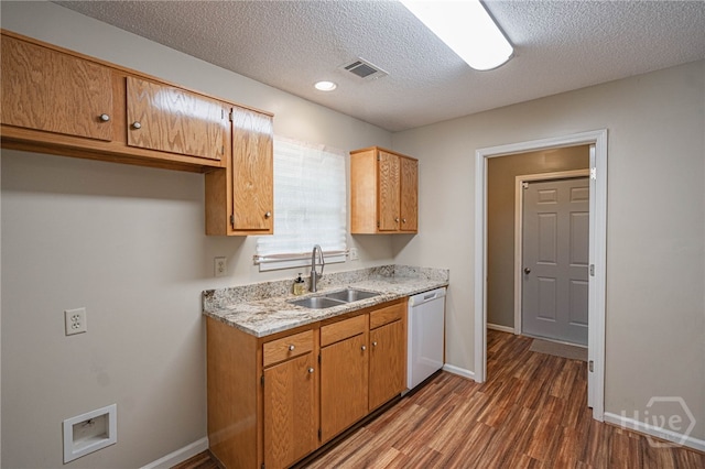 145 New Stillwell Rd, Springfield, GA 31329 - kitchen with dishwasher, a sink, dark wood finished floors, baseboards, and a textured ceiling