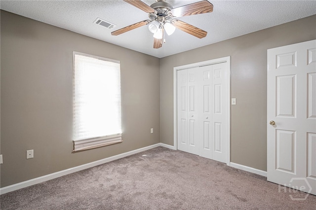 145 New Stillwell Rd, Springfield, GA 31329 - unfurnished bedroom with carpet floors, a closet, baseboards, a ceiling fan, and a textured ceiling