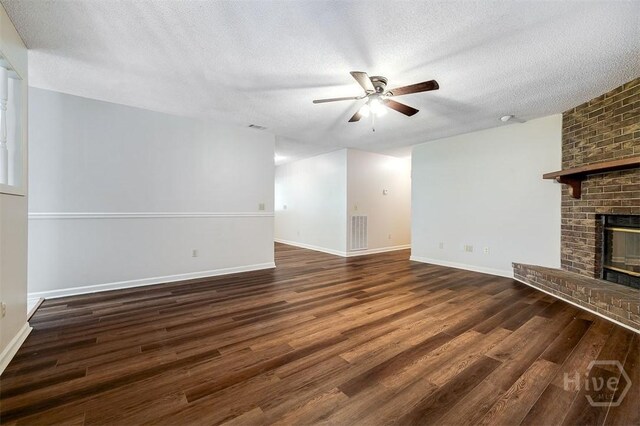 1282 Long Bridge Rd, Rincon, GA 31326 - unfurnished living room featuring a ceiling fan, wood finished floors, a textured ceiling, a fireplace, and baseboards