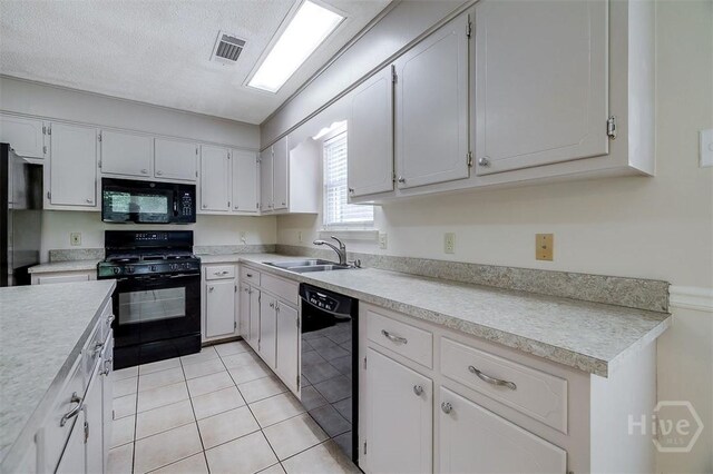 1282 Long Bridge Rd, Rincon, GA 31326 - kitchen featuring black appliances, a sink, light countertops, white cabinets, and light tile patterned flooring