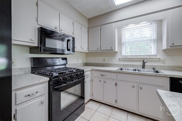 1282 Long Bridge Rd, Rincon, GA 31326 - kitchen featuring black appliances, a sink, light countertops, a textured ceiling, and light tile patterned floors