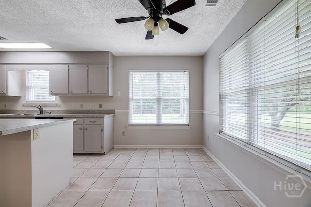 1282 Long Bridge Rd, Rincon, GA 31326 - kitchen featuring light countertops, a textured ceiling, ceiling fan, light tile patterned floors, and baseboards
