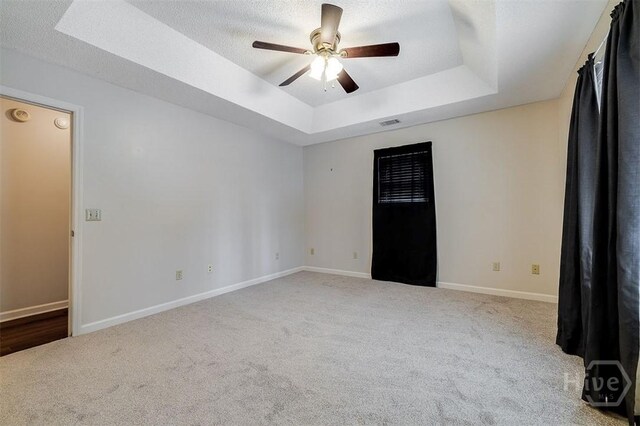 1282 Long Bridge Rd, Rincon, GA 31326 - unfurnished room with a tray ceiling, ceiling fan, carpet floors, baseboards, and a textured ceiling