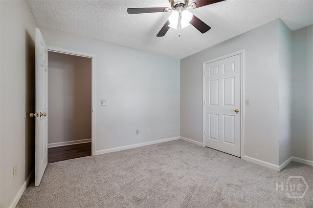1282 Long Bridge Rd, Rincon, GA 31326 - unfurnished bedroom with carpet flooring, a textured ceiling, baseboards, and a ceiling fan