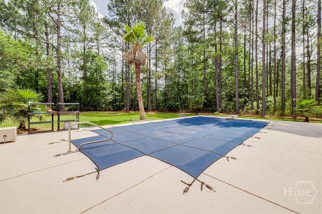 1282 Long Bridge Rd, Rincon, GA 31326 - view of swimming pool featuring a diving board, a covered pool, a patio area, and a lawn