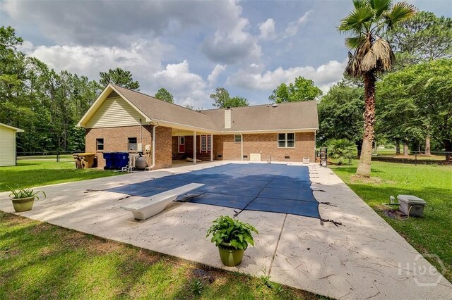 1282 Long Bridge Rd, Rincon, GA 31326 - view of pool featuring a diving board, a patio, a lawn, and a covered pool