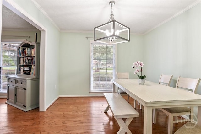 1409 Bellview Dr, Savannah, GA 31406 - dining area with a chandelier, light wood-type flooring, baseboards, and ornamental molding