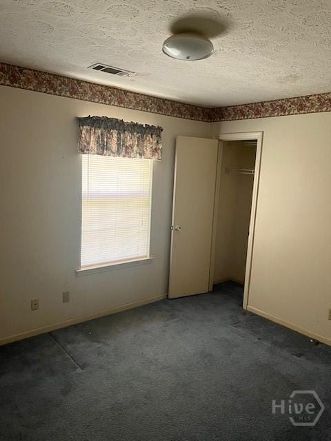 887 Piercefield Dr, Richmond Hill, GA 31324 - unfurnished bedroom featuring carpet flooring, a textured ceiling, baseboards, and a closet