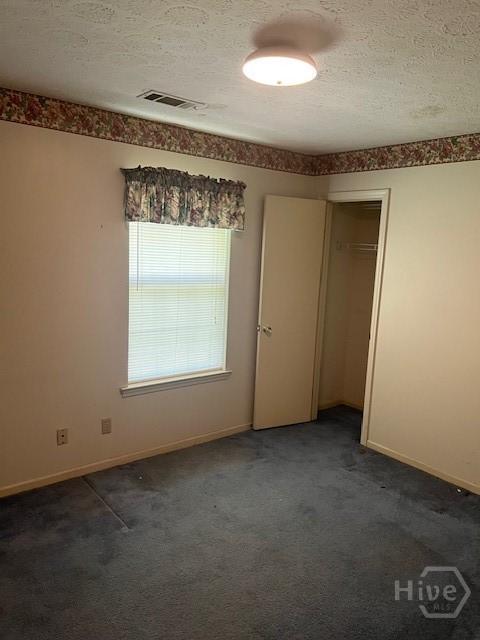 887 Piercefield Dr, Richmond Hill, GA 31324 - unfurnished bedroom with a textured ceiling, carpet, baseboards, and a closet