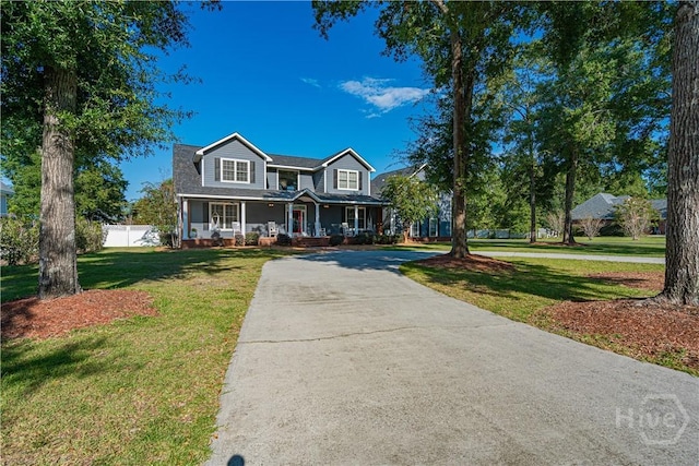 view of front of house featuring covered porch, a front lawn, and concrete driveway