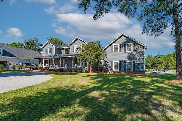 traditional-style house with a porch and a front yard