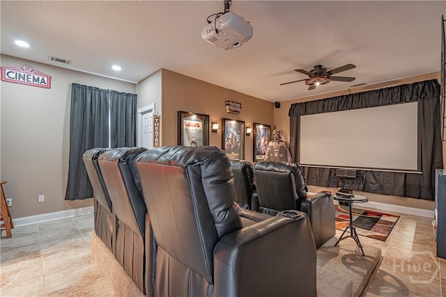 home theater room featuring ceiling fan, a textured ceiling, recessed lighting, baseboards, and light tile patterned floors