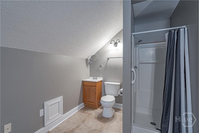 full bath featuring a textured ceiling, a stall shower, vanity, baseboards, and toilet