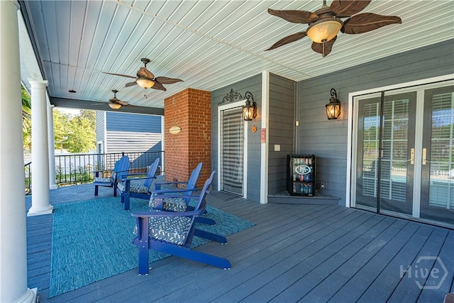 wooden porch featuring a ceiling fan