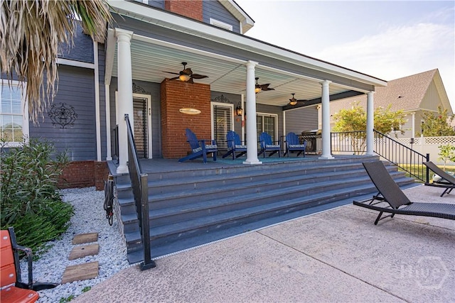 wooden porch featuring a ceiling fan