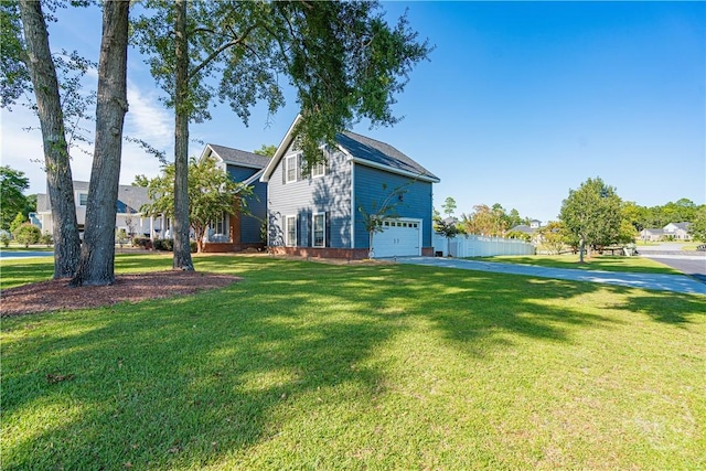 view of front of house with a garage, driveway, and a front lawn