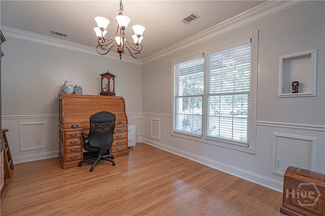 office space featuring light wood-style floors, a chandelier, a decorative wall, a wainscoted wall, and a textured ceiling