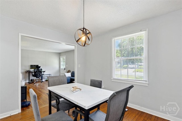 103 Pine Valley Rd, Savannah, GA 31404 - dining area with wood finished floors, a textured ceiling, and baseboards