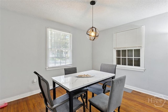 103 Pine Valley Rd, Savannah, GA 31404 - dining area with baseboards, a textured ceiling, and wood finished floors