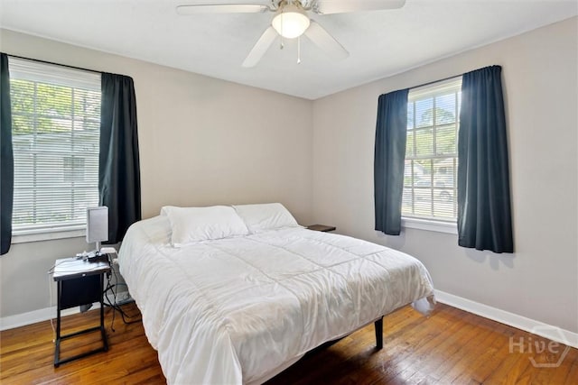 103 Pine Valley Rd, Savannah, GA 31404 - bedroom with multiple windows, baseboards, wood finished floors, and ceiling fan