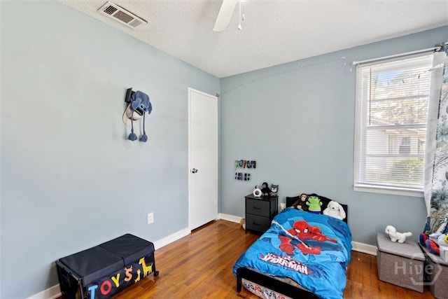 103 Pine Valley Rd, Savannah, GA 31404 - bedroom with multiple windows, wood finished floors, baseboards, and a textured ceiling