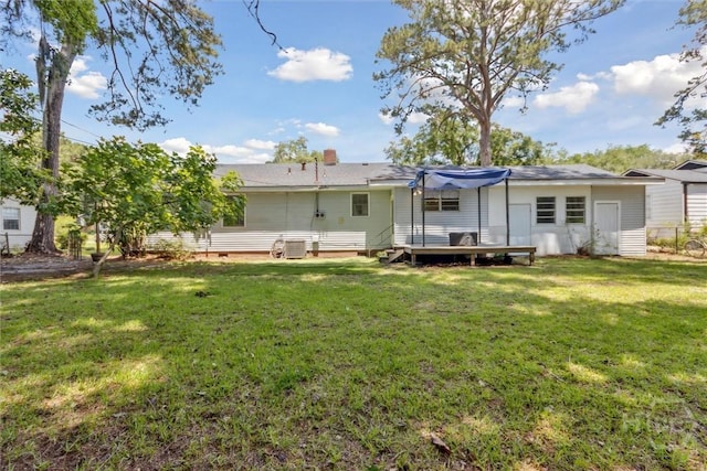 103 Pine Valley Rd, Savannah, GA 31404 - back of house featuring a lawn, a wooden deck, and a chimney