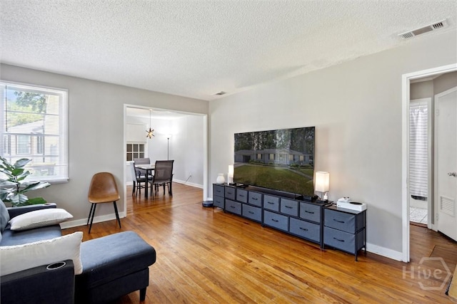 103 Pine Valley Rd, Savannah, GA 31404 - living area with wood finished floors, a textured ceiling, and baseboards