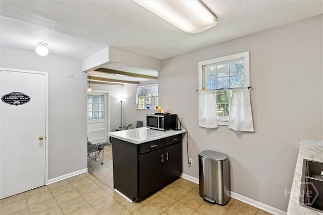 103 Pine Valley Rd, Savannah, GA 31404 - kitchen with a peninsula, dark cabinetry, baseboards, light countertops, and a sink