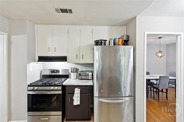 103 Pine Valley Rd, Savannah, GA 31404 - kitchen featuring stainless steel appliances, under cabinet range hood, white cabinetry, and light wood-style floors