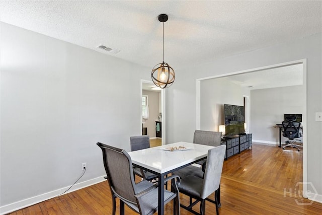 103 Pine Valley Rd, Savannah, GA 31404 - dining room with hardwood / wood-style floors, baseboards, and a textured ceiling