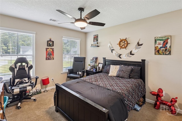 110 Vintage Dr, Guyton, GA 31312 - bedroom featuring light colored carpet, multiple windows, baseboards, a textured ceiling, and a ceiling fan