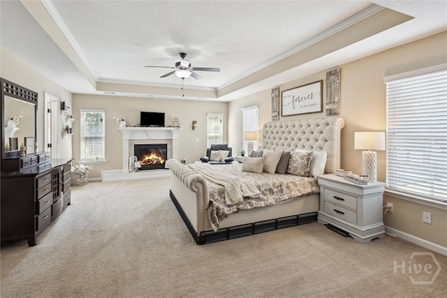 110 Vintage Dr, Guyton, GA 31312 - bedroom with a tray ceiling, light colored carpet, ornamental molding, a glass covered fireplace, and baseboards